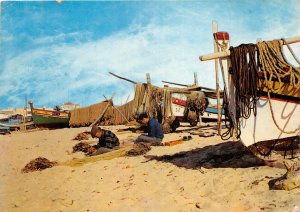 Lot269 algarve portugal fishermen repairing the fishing nets