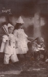 Children types and scenes harlequin costumes teasing Davidson quality postcard