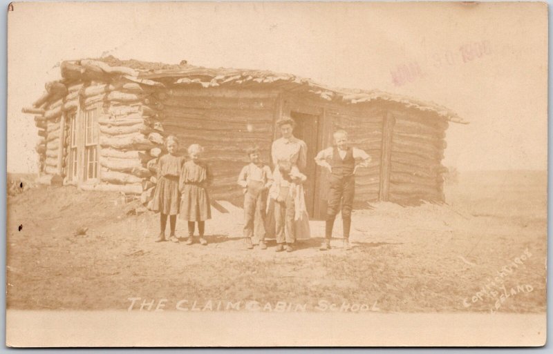 The Claim Cabin School Teacher  and Students Real Photo RPPC Postcard 