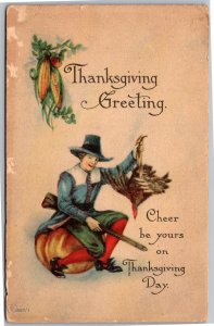 Postcard Thanksgiving Bergman Pilgrim on Pumpkin holding gun and turkey