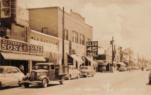 RPPC OBREGON AVENUE NOGALES MEXICO CARS SIGNS REAL PHOTO POSTCARD (c. 1930s)