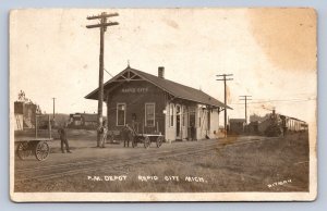 J95/ Rapid City Michigan RPPC Postcard c1910 P.M. Railroad Depot 481