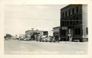 c1940 RPPC Postcard N. Main Street, Gordon NE Sheridan Co. Business Signs Cars