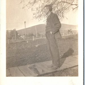 c1910s Man Standing Looking Afar RPPC Wood Deck Tree Vtg Real Photo Postcard A94