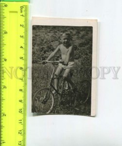 474196 USSR little boy sunbathing on a bike Vintage photo