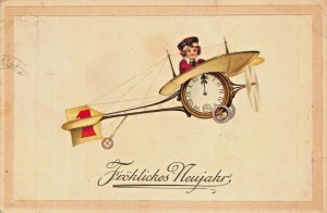 FROHLICHES  NEUJAHR~YOUNG BOY IN AIRPLANE WITH CLOCK-1913 NEW YEAR POSTCARD