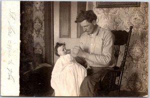 Man Feeding A Baby Doll White Dress Hair Vintage Postcard