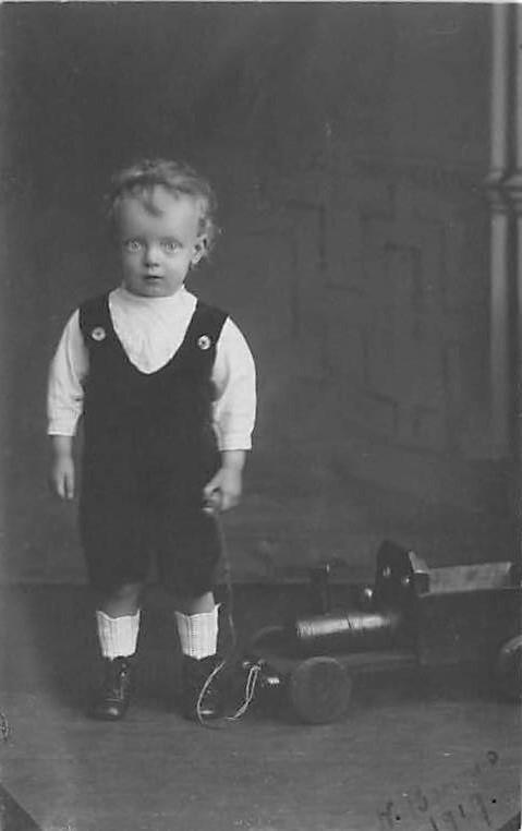 Child pulling a toy Child, People Photo Writing on back 