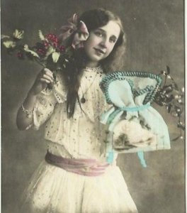 Beautiful girl holding a blue Sachel and Holly Branch in Colorized Sepia Gold