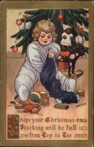 Christmas - Child Going Thru Stocking - Marion Miller c1910 Postcard rpx