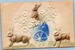 Easter Greetings bunny pulling blue egg wagon embossed by Illustrated Post Card
