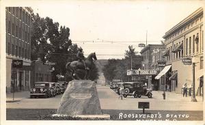 Mandan ND Roosevelt Statue Chevrolet Dealership Movie Theatre RPPC Postcard