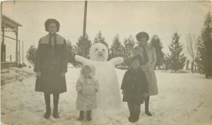 C-1910 Winter Snowman women Children RPPC Photo Postcard 22-9743