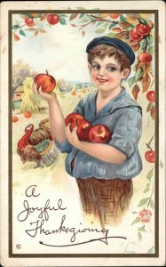 Thanksgiving Boy Apple Picking Turkey Gilt Embossed Stecher c1900s-10s Postcard