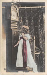 Girl next to big grandfather clock Child, People Photo 1905 light writing top...