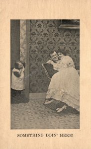 1909 Something Doing Here Child Looking Lovers Cuddling Romance Vintage Postcard