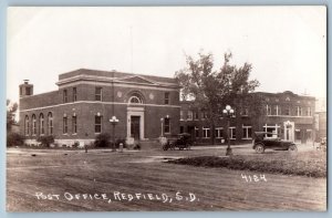 Redfield SD Postcard RPPC Photo Post Office Building Cars Dirt Road c1940's