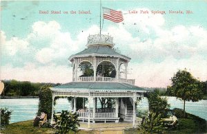 1909 Nevada Missouri Band Stand Island Lake Park Springs Flag Postcard 26-419