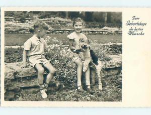 old rppc foreign PRETTY GIRL PLAYING WITH CUTE SCRUFFY DOG HM0954