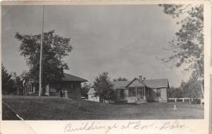 Couple Walking by Buildings @ Government Dam~RPPC Mailed @ Jenkins Minnesota