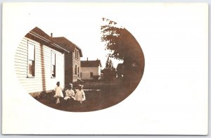 Vintage Real Photo Postcard RPPC Children Sitting Yard Houses Early 1900s