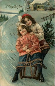 Christmas Young Girls Sledding Gilt Inlay c1910 Vintage Postcard