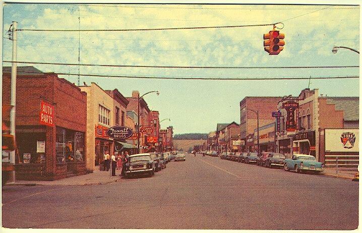 Iron River MI Main Street Storefronts Rexall Drug Store Old Cars Postcard