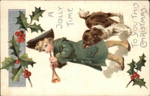 Christmas Little Boy Blowing Horn with Spaniel Dog c1910 Postcard