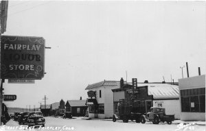 H49/ Fairplay Colorado RPPC Postcard c1950s Liquor Store Trucks Stores