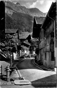 RPPC Switzerland Brienz village - woman walking down road