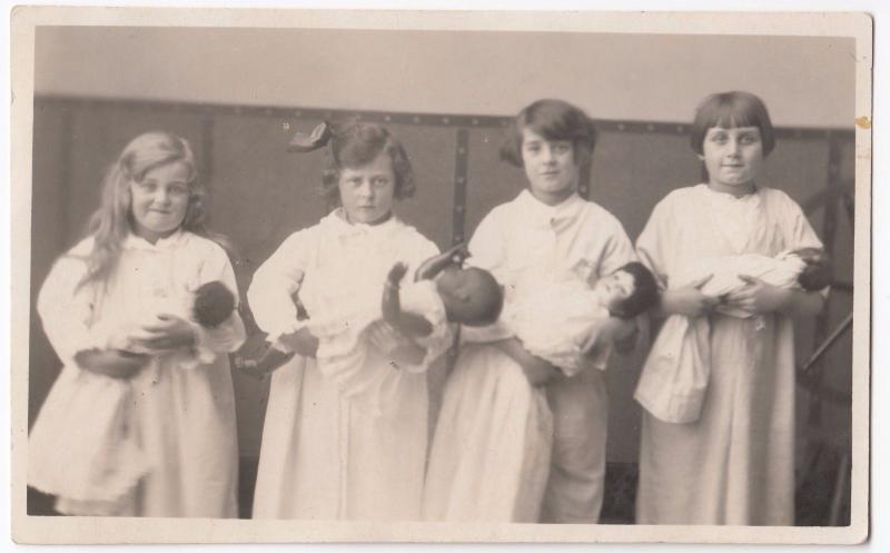 Social History, Group of Children With Baby Dolls in Swaddling RP PPC, c 1910's