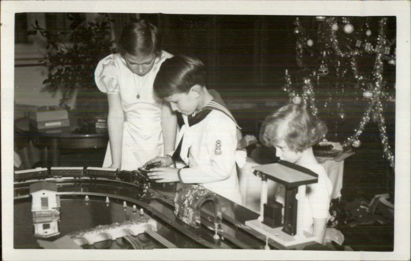 Christmas Morning Kids Toy Train Set Brother & Sister Real Photo Postcard 1937