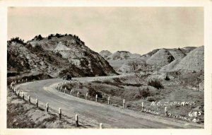 NORTH DAKOTA BADLANDS-OLD CAR ON HIGHWAY~1930s OSBORN REAL PHOTO POSTCARD