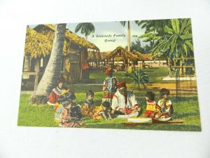 PPC POSTCARD NATIVE AMERICAN A SEMINOLE FAMILY GROUP MAN TEACHING CHILDREN