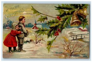 1906 Christmas Greetings Boy Girl Hiding Bridge Bells Holly Berries Postcard
