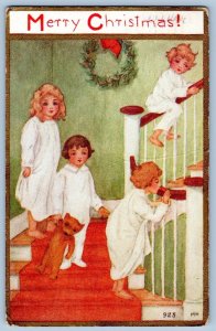 1913 MERRY CHRISMAS TEDDY BEAR CHILDREN IN PAJAMAS WREATH ANTIQUE POSTCARD