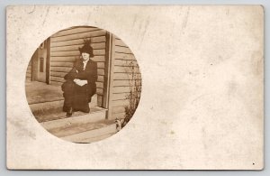 RPPC Edwardian Woman Sitting On Porch Step Wearing Winter Coats Hat Postcard R27