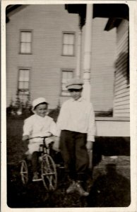 RPPC Darling Boys Teaching Little Brother to Ride Velocipede Bicycle Postcard U2