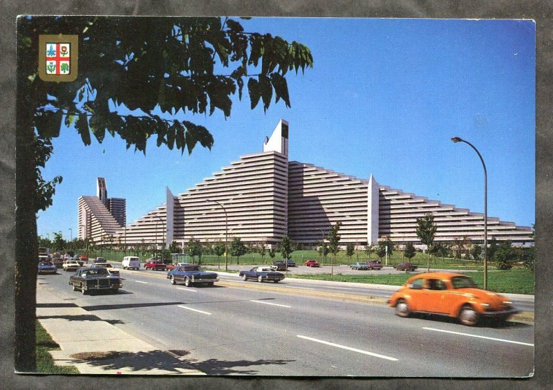 p38 - MONTREAL Olympic Village Postcard. Mailed 1983. VW Beetle. Maple Leaf Coil