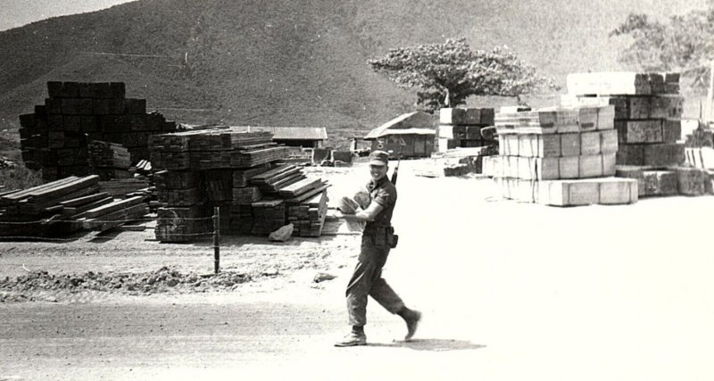 1960s VIETNAM WAR ARMY CAMP LUMBER STACKS SOLDIER PHOTO RPPC POSTCARD 43-185