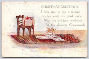 Christmas Greetings Small Package In Wooden Chair Greetings & Wishes Postcard