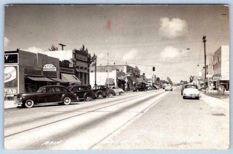 1940's DANIA FLORIDA RPPC MAIN STREET DEVOE PAINTS PABST ON DRAFT LIQUORS REXALL