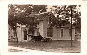 Real Photo Postcard Man in Early Open-Air Automobile Outside a House