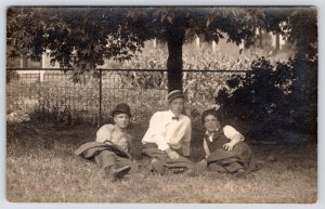 RPPC St Paul? Cornfield~Men w/Varied Hats Relax Under Tree~Jackets Drape Legs