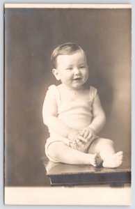 RPPC Stool Sitting Baby w/Broad Smile & Long Dark Coiffed Hair~Chubby Fingers PC