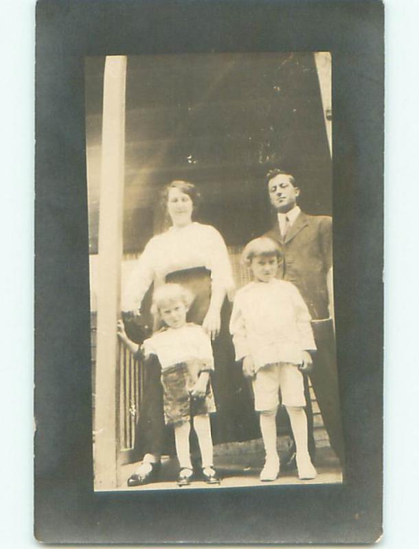 Pre-1918 rppc FAMILY STANDING ON THE PORCH o2021