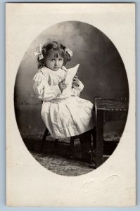 c1910's Pretty Little Girl Holding Book Studio Gibbon MN RPPC Photo Postcard