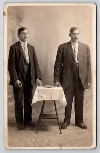 RPPC Two Handsome Young Men Standing At Table Studio Photo Postcard B39