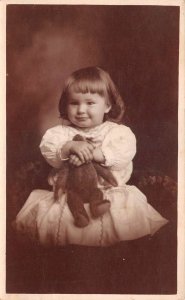 Girl holding Teddy Bear Real Photo Vintage Postcard AA69879