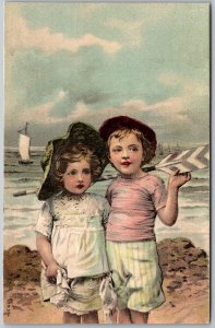 Children At The Seashore c1910 Embossed Postcard Girl Boy With Oar